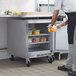 A man putting food into a Beverage-Air undercounter refrigerator.