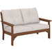 a white couch with brown armrests