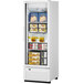 A Turbo Air white swing door freezer full of food.