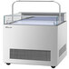 A white rectangular refrigerator with a glass top.