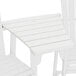 A close up of a white POLYWOOD Adirondack connecting dining table with a square top.