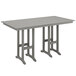 A POLYWOOD slate grey bar height table on an outdoor patio.