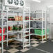 A Cambro Premium Camshelving unit with vented shelves in a storage room.