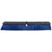 A blue and black Carlisle Sparta Spectrum Omni push broom head.
