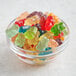 A bowl of Albanese 12-flavor gummi bears on a table.