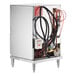 A Noble Warewashing high temperature undercounter dishwasher with wires and pipes.