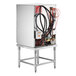 A Noble Warewashing stainless steel undercounter dishwasher with pipes and wires.