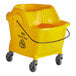 A yellow Lavex 35 Qt. mop bucket with wheels.