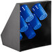 A black metal flatware organizer with blue plastic cylinders inside.