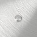 An aluminum pot/pan cover with a water drop on the surface.
