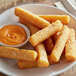 A plate of White Toque steak-cut Yuca fries with orange sauce.