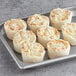 A White Toque pan with six individual potato au gratins.