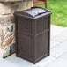 A brown Suncast trash container with a wicker pattern.