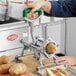 A person using a Garde potato wedge cutter on a table to cut potatoes.