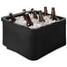 A black IRP countertop merchandiser with six brown bottles of beer in it.