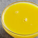 a glass bowl of yellow liquid