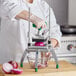 A woman using a Garde XL Heavy-Duty Large Vegetable Dicer to slice a red onion.