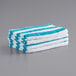 A stack of Monarch Brands blue and white striped pool towels.