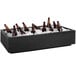 A black rectangular IRP countertop cooler filled with brown bottles of beer on ice.