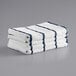 A stack of Monarch Brands navy and white striped towels.