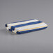 A navy blue and yellow striped Monarch Brands pool towel.