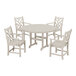 A white POLYWOOD table with four arm chairs around it.