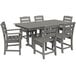 A POLYWOOD slate grey rectangular dining table with six chairs on an outdoor patio.