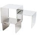 An American Metalcraft stainless steel display riser set on a silver metal table with a white background.