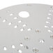 A circular metal plate with holes.