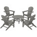 A POLYWOOD slate grey table with four Adirondack chairs on an outdoor patio.