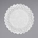 A white Lace Normandy doily on a gray background.