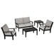 A black and grey POLYWOOD outdoor furniture set with chairs, a settee, and tables.