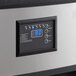 A black and silver rectangular control panel with a digital display.