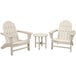 A round white table with legs and three white Adirondack chairs with armrests.