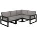 A black and grey POLYWOOD sectional couch with cushions.