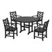 A POLYWOOD black outdoor dining table with chairs around it, including four with armrests.