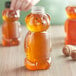 a plastic bear shaped bottle with a lid