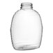 A clear plastic Queenline honey bottle with a lid.