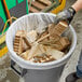 A person holding a Lavex Pro trash bag in a trash can.