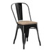 A Lancaster Table & Seating black metal chair with a gray wood seat.