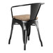 A Lancaster Table & Seating black metal chair with a wooden seat.