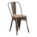 A brown metal Lancaster Table & Seating cafe chair with a gray wood seat.