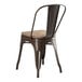 A brown metal Lancaster Table & Seating cafe chair with a wooden seat.