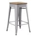 A Lancaster Table & Seating gray metal backless counter height stool with a gray wood seat.