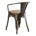 A copper Lancaster Table & Seating metal arm chair with a gray wood seat.