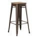 A brown Lancaster Table & Seating backless barstool with a gray wooden seat.