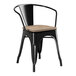 A Lancaster Table & Seating black metal chair with a gray wood seat.