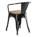 A Lancaster Table & Seating black metal chair with a wood seat.