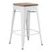 A white Lancaster Table & Seating backless counter height stool with a gray wood seat.