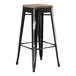 A Lancaster Table & Seating black metal barstool with a gray wood seat.